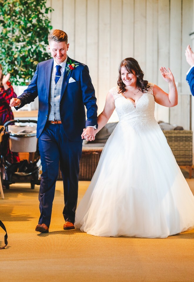 bride and groom dancing into room