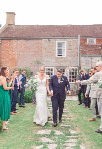 Couple being showered in confetti at Midelney Manor Wedding Venue Somerset