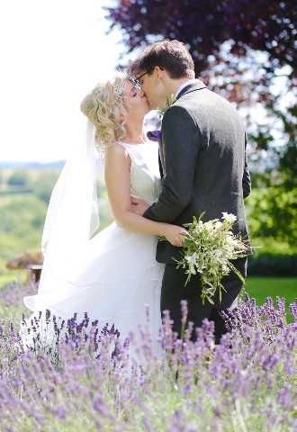 bride and groom share a kiss surrounded by lavender Charingworth Manor Cotswolds, photo by SMD Wedding Photography, west midlands