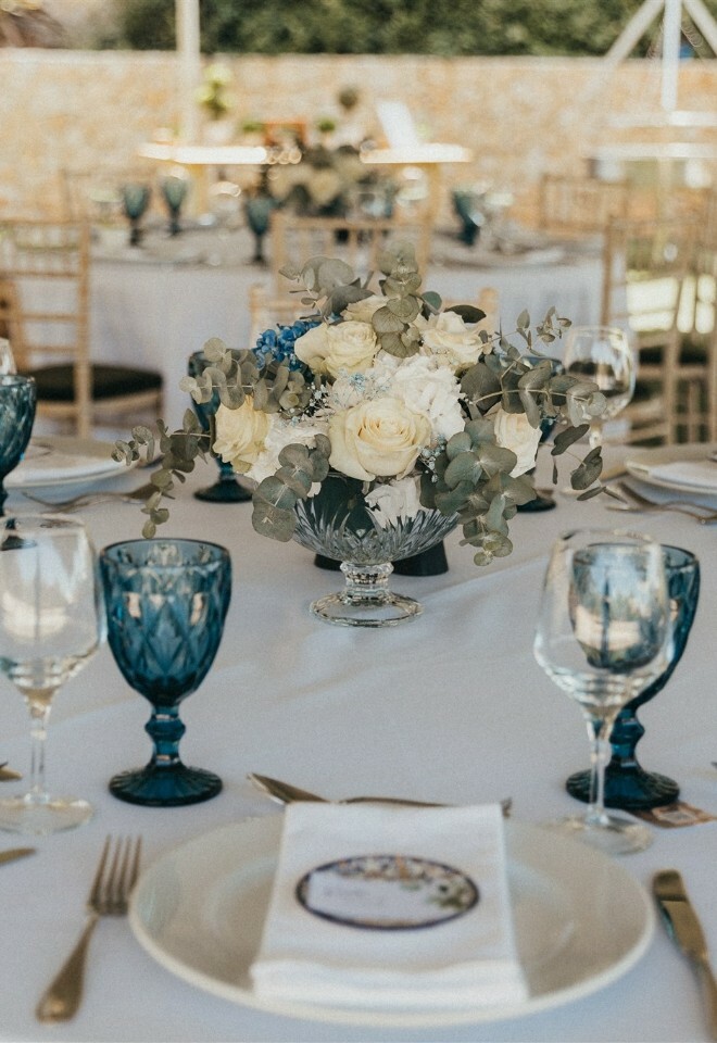 Low Round Tale flower arrangement featuring Portuguese Blue Tile Favours and Water Glasses 