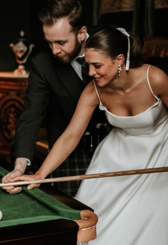 Wedding couple playing pool at Melville Castle - a castle wedding venue near Edinburgh