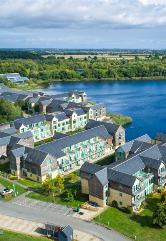 A drone shot of the hotel with the lake in the background