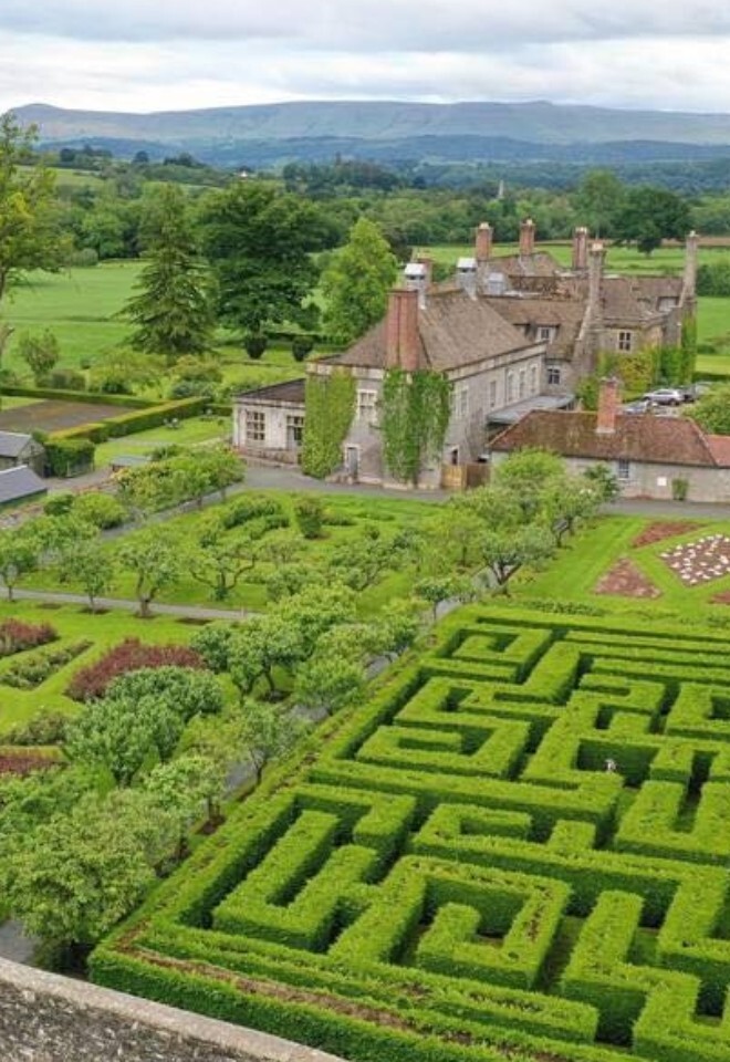 Llangoed Hall Gardens with hedge maze and walled.