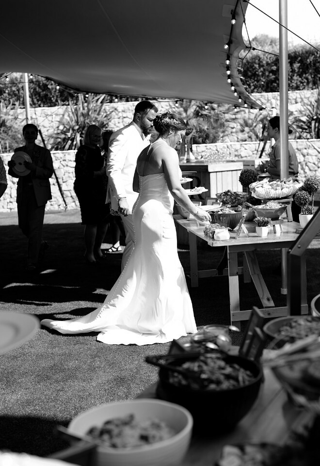 Couple getting food from the Wedding BBQ at Casa Monte Cristo
