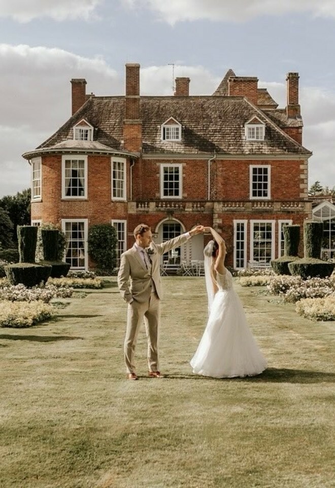 Bride and groom dancing in the gardens
