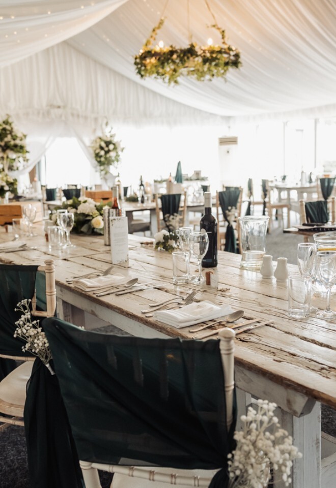 A dining area setup in the marque at a Warwickshire wedding venue