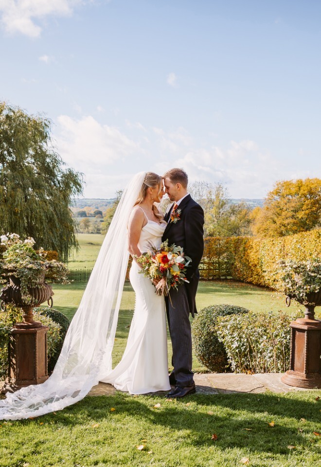 Romantic summer wedding portrait of a couple embracing at Merriscourt in Oxfordshire