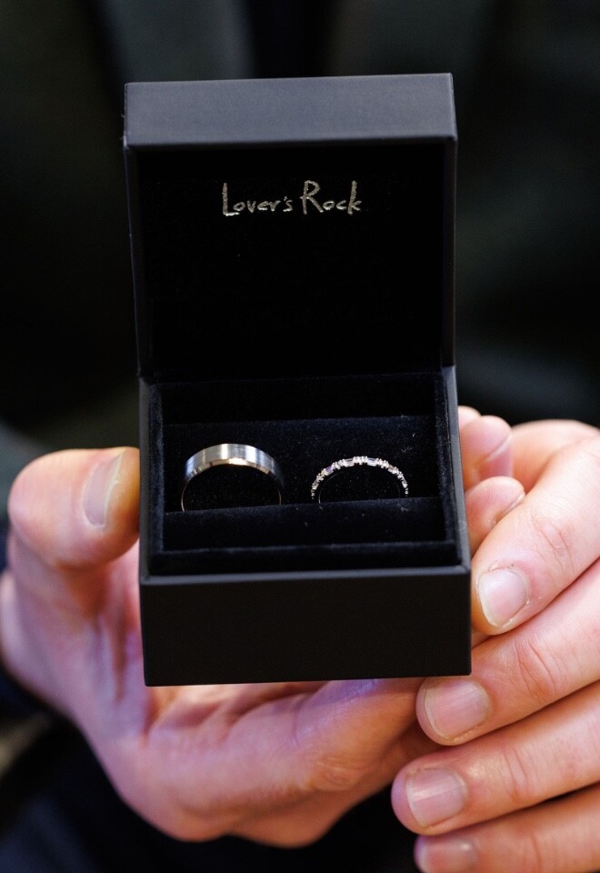 Silver his and hers wedding rings displayed in an open ring box