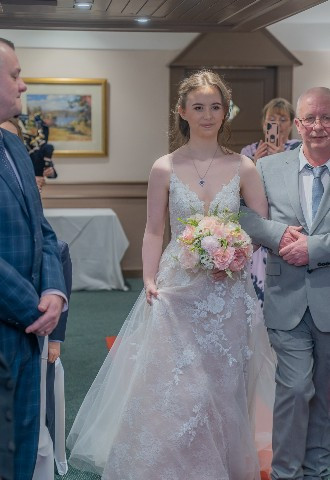 bride walking down the aisle at Britannia Waterside Hotel Peterhead