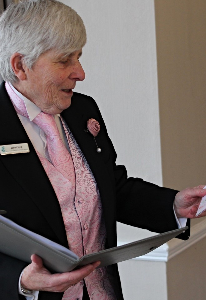 Jane wearing pink reading at wedding