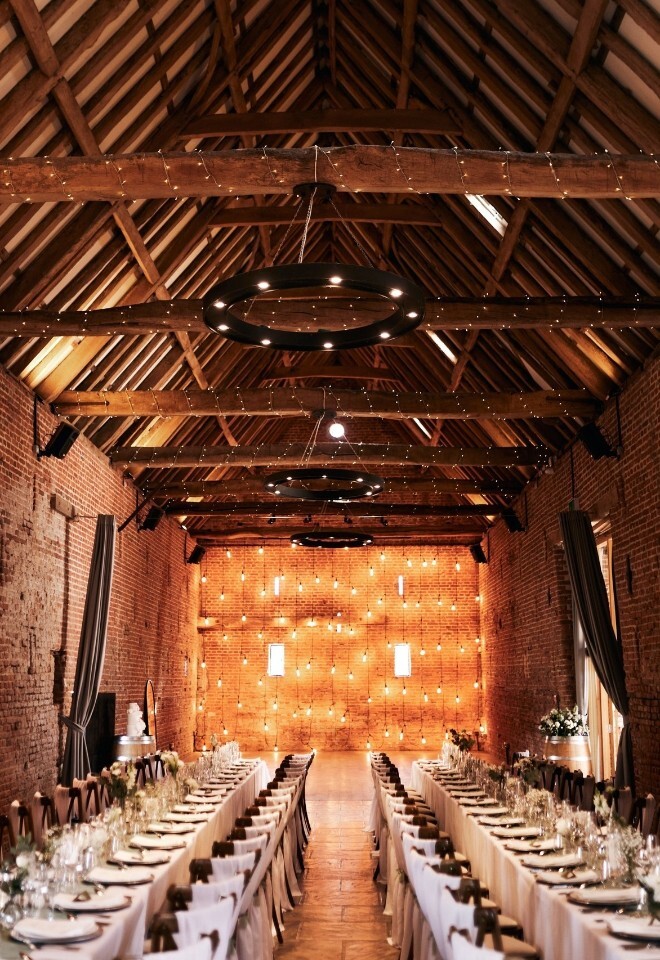 Wedding reception setting with tressel tables inside the Barn