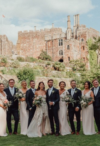 Berkeley Castle acting as the backdrop for couples group wedding photos