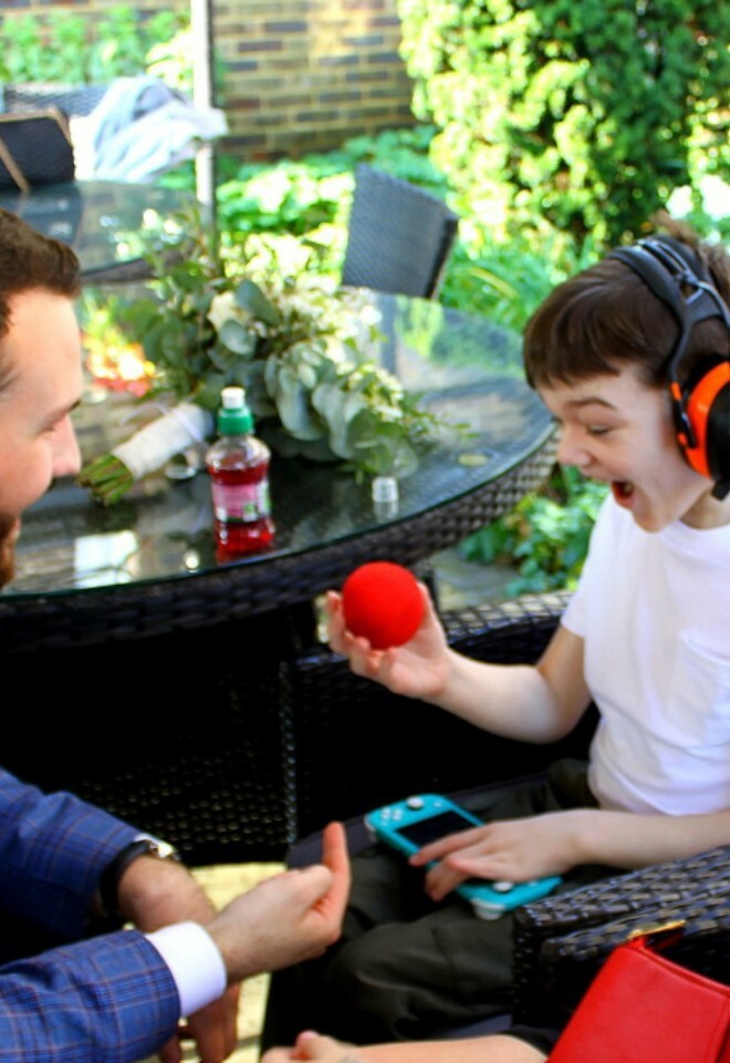 a beautiful moment of magic where an autistic boy is engaged by magic