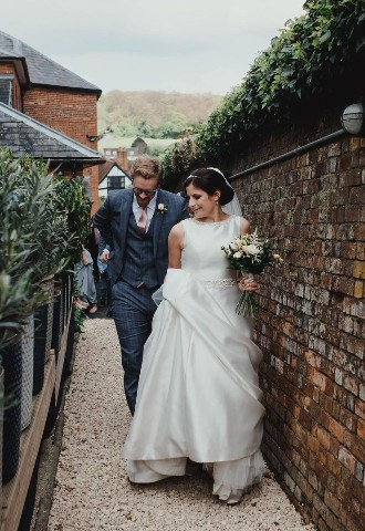 Wedding couple walking to Walled Garden at Kings Chapel, Amersham