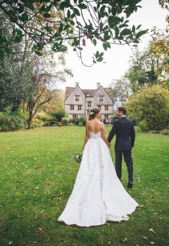 Bride and groom walk together across the lawn of the Egypt Mill gardens on their wedding day