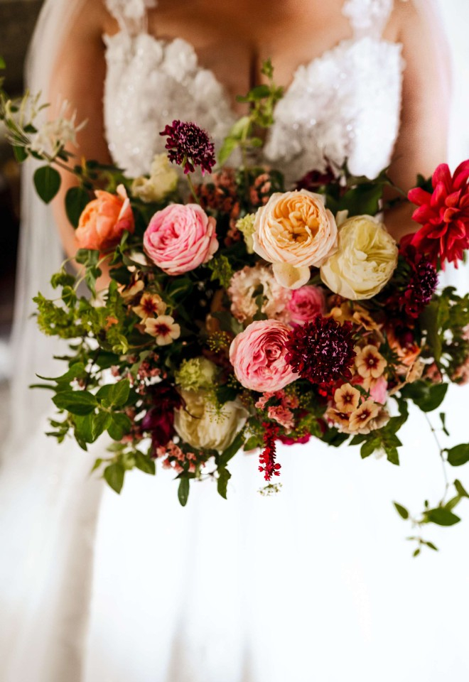 Bouquet of bright spring flowers and trailing foliage including phlox, roses, dahlias, honeysuckle, scabiosa, eustoma and jasmine at Offley Place