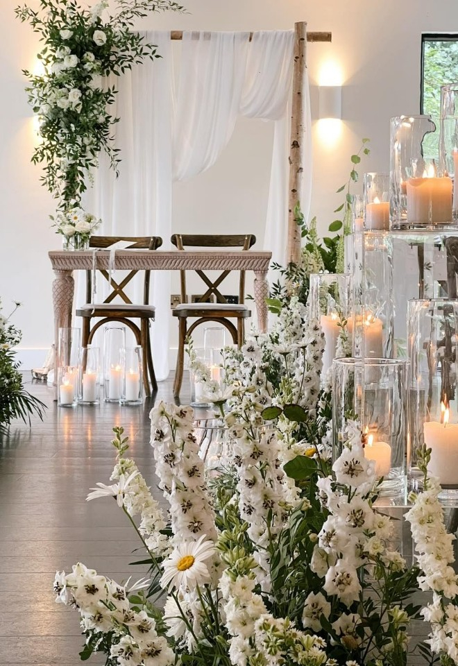 Flowers and candles in the aisle at The Woodlands at Hothorpe