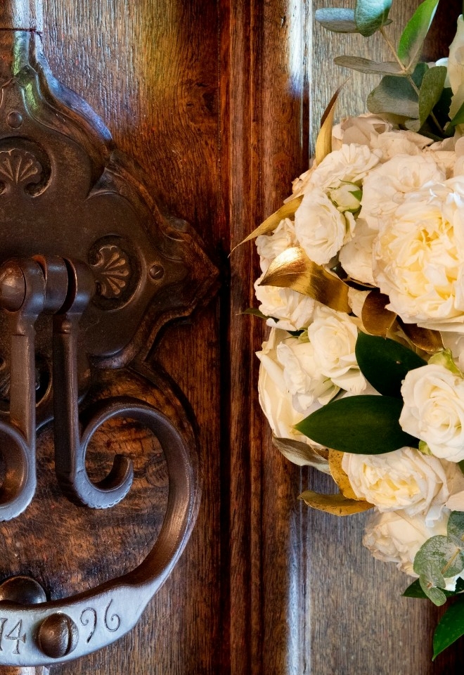 close up door knocker with wedding flowers