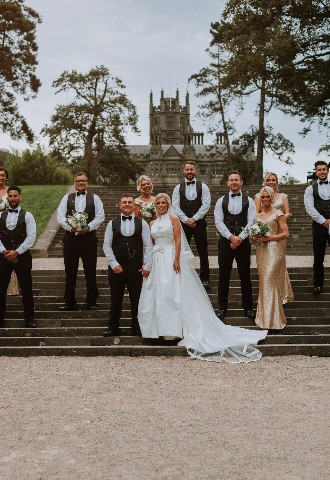 Bride, groom and the wedding party pose for photos at Margam Country Park, Neath Port Talbot
