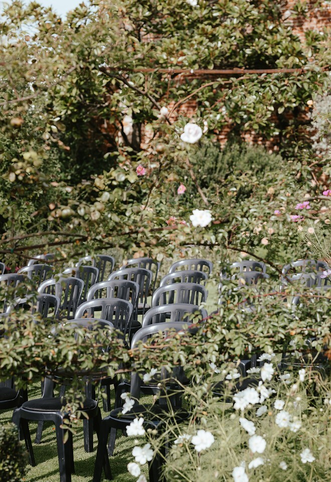 Outdoor ceremony feeling like a fairy garden amongst the roses