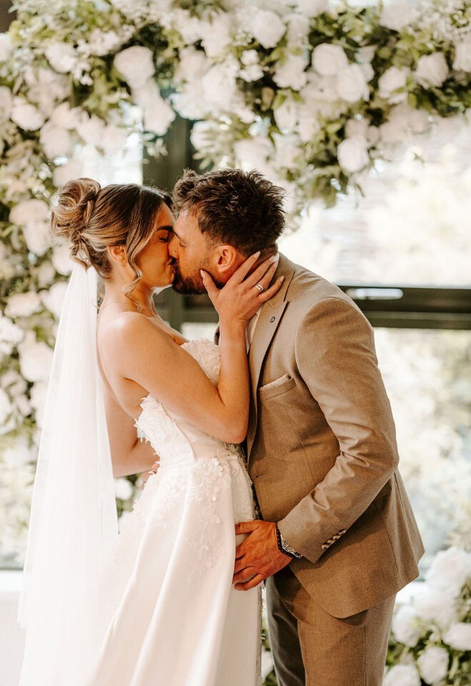 bride and groom share a kiss
