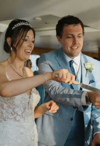 bride and groom cutting their wedding cake at their wedding reception on a yacht in cyprus