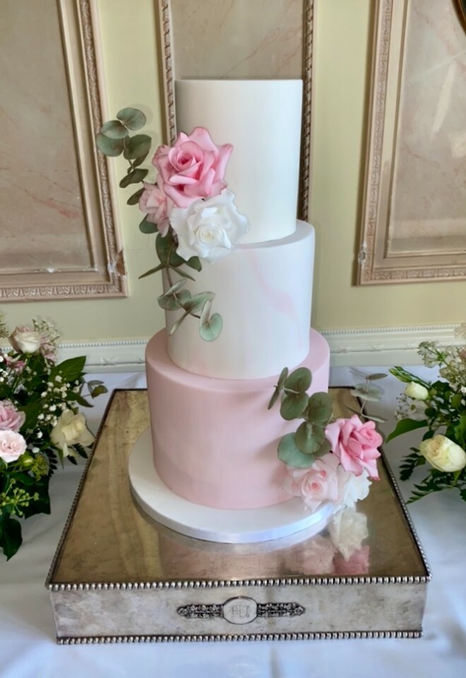 Pink and white wedding cake with flowers for a wedding at Danesfield House by Cakes of Curiosity.