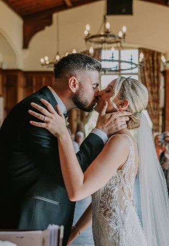 Bride and groom share their first kiss at Chateau Rhianfa, Anglesey