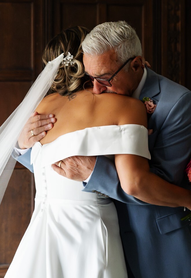 Bride and her dad hug