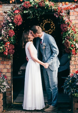 Bride and groom share their first kiss at The Secret Garden, Duffryn Mawr
