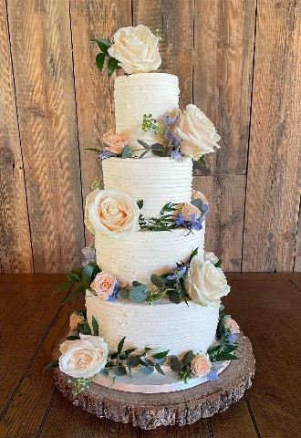 CuFour tier buttercream wedding cake with fresh pastel flowers made by Celebration Cakes by Catherine Scott in Oxfordshire