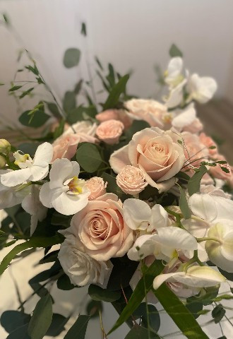 white orchids, peach roses bridal bouquet from Oops A Daisy in Cirencester
