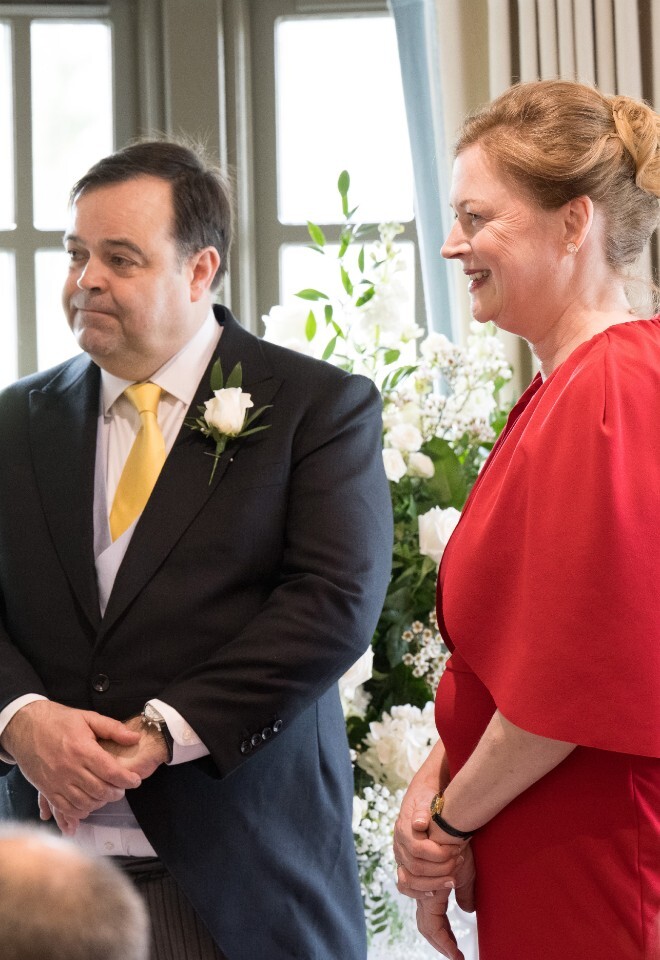 Bride and Groom at their ceremony, bride is dressed in red