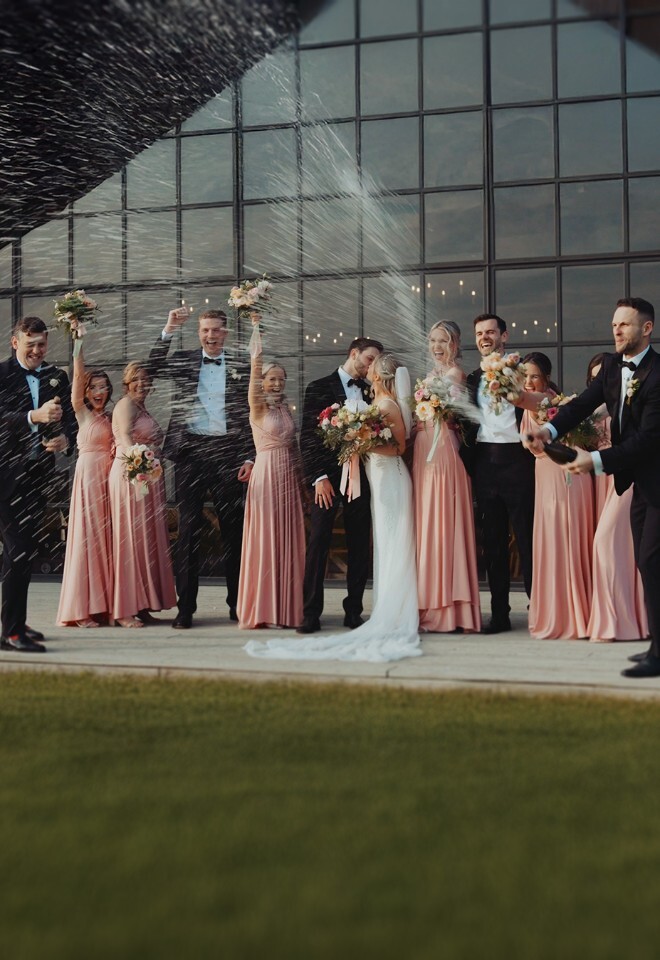 Bridal party spraying champagne