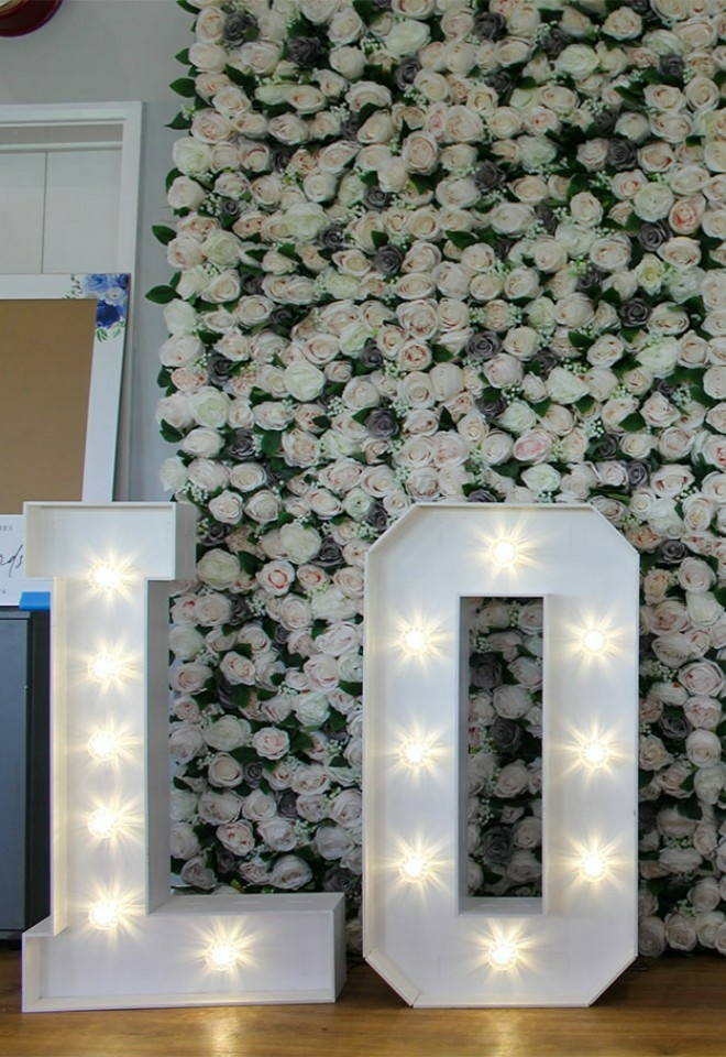 LED Love Letters Against Flower Wall, Buckinghamshire Wedding