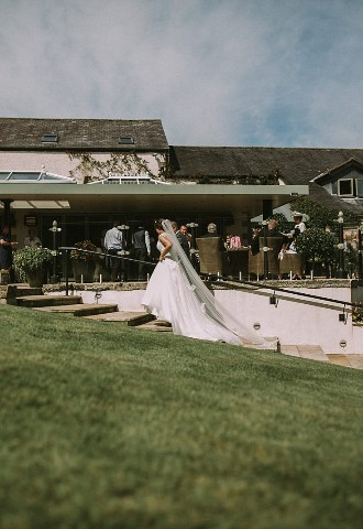 Bride and groom exploring the gardens at Gibbon Bridge Hotel, Lancashire