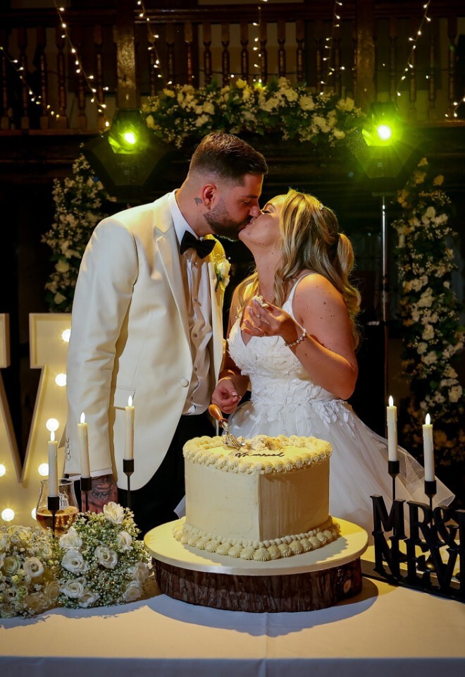 Vicky and Lukes wedding cake cutting during wedding at Box Hill Burford Bridge