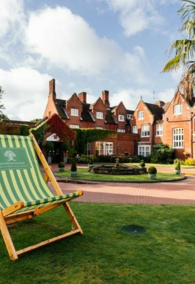 Giant green deckchair and palm tree at the front of the hotel- Sprowston Manor Norwich