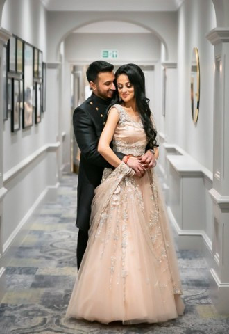 Voco St Johns hallway with bride and groom embracing