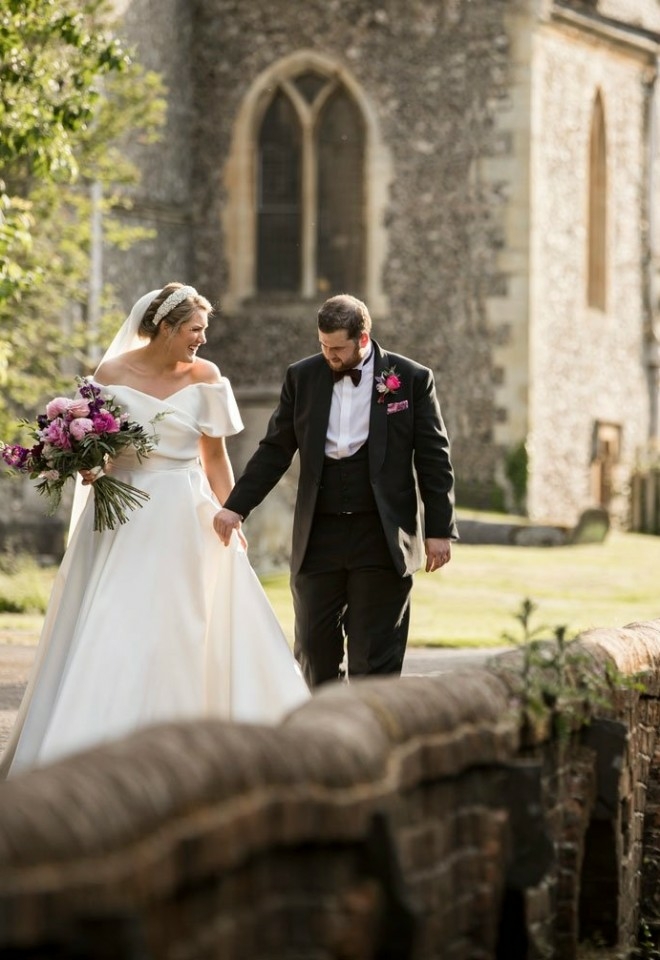 Couple outside church by the river