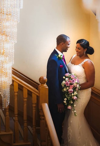 Bride and groom pose on the staircase at Park Hall Hotel, Wolverhampton