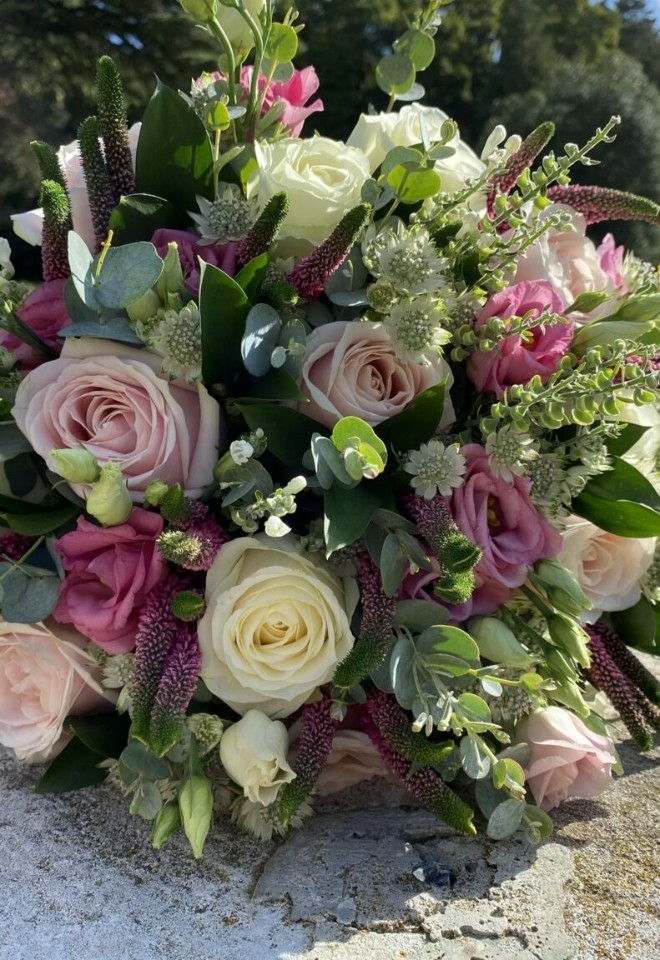pink and white flower bouquet by hire heaven
