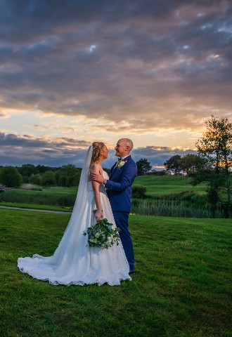 Bride and groom enjoying the sunset at East Sussex National