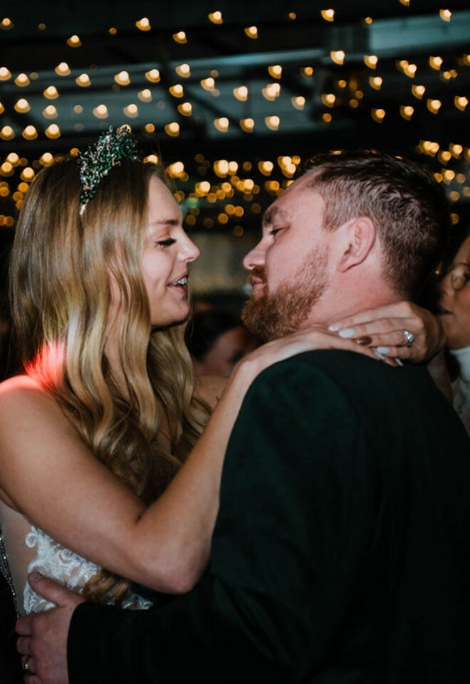 Couple first dance under fairy lights