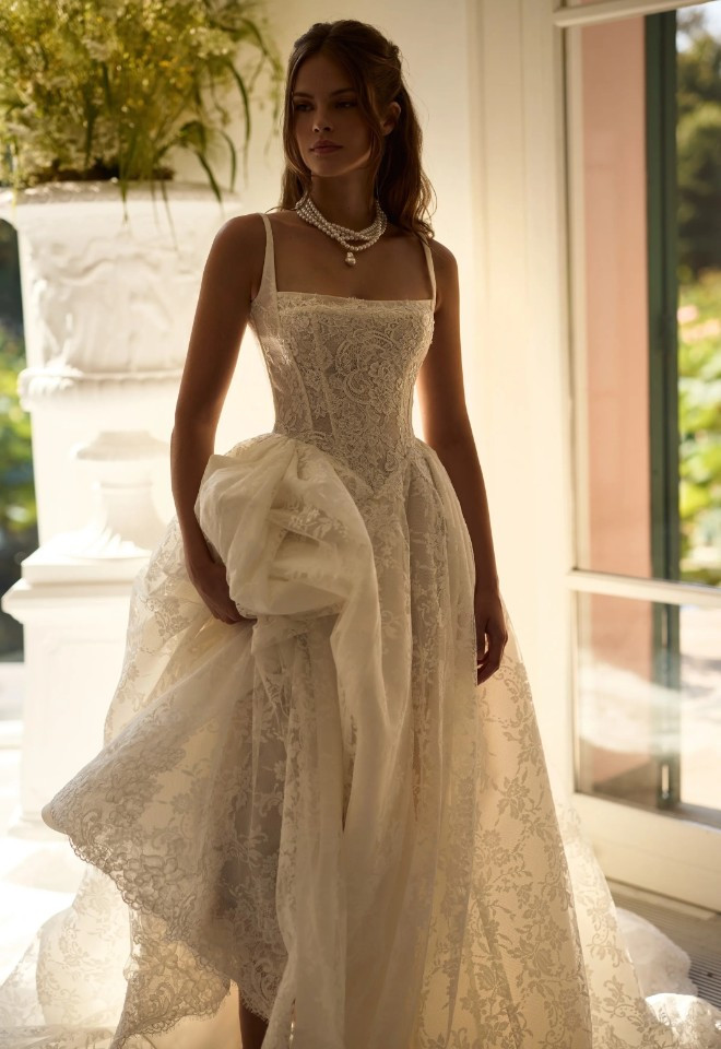 Melrose by Milla Nova - Bride in an elegant lace A-line wedding dress with a square neckline and full skirt.