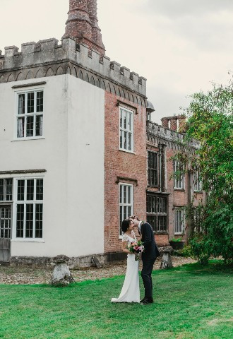 Bride and groom share a kiss at Nether Winchendon House, Buckinghamshire