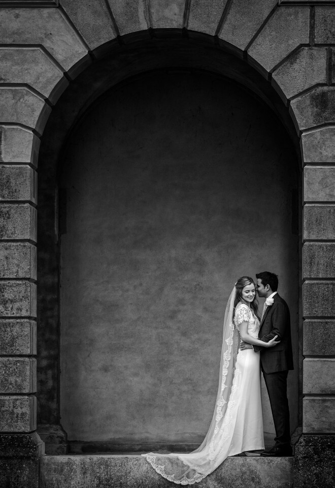 Wedding couple under a stone arch