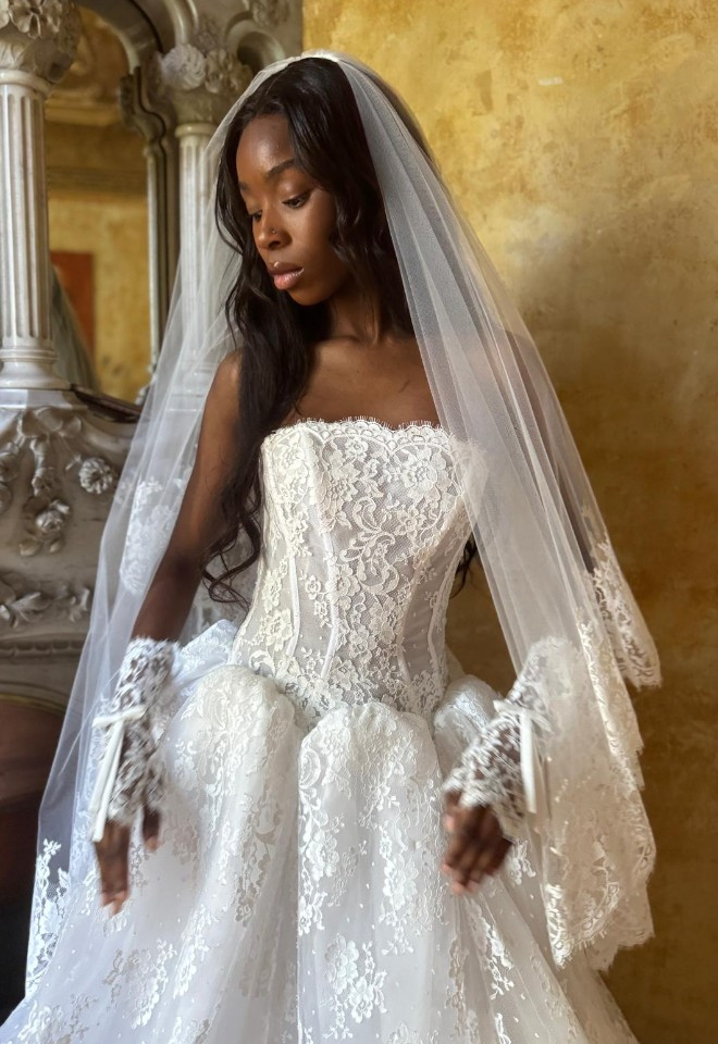 a show stopping lace ballgown with a clean neckline and drop waist. complete with matching lace gloves and veil.