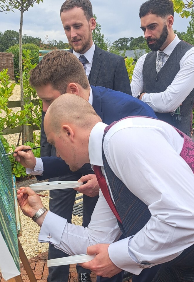 guest painting at wedding