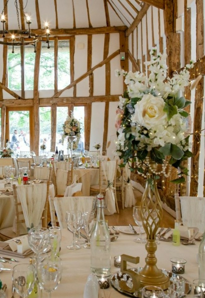 White flowers on a table in wedding breakfast setup
